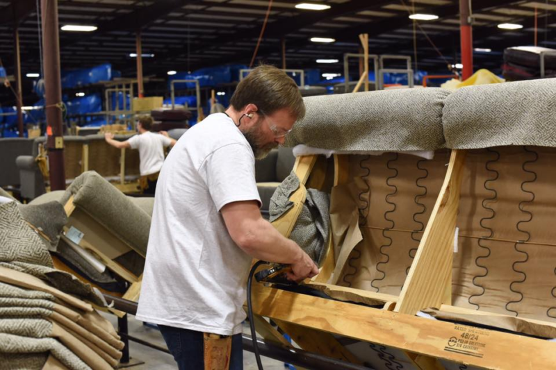 England Furniture craftsman upholstering a sofa